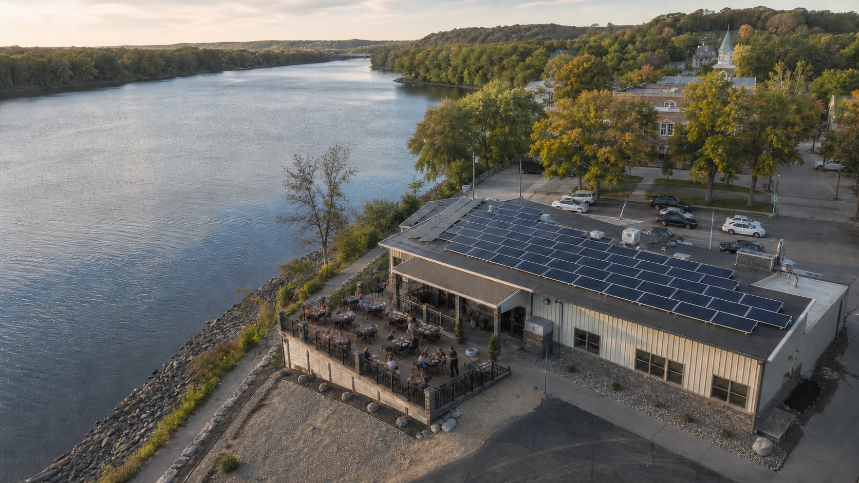Aerial view of a riverside Illinois restaurant with solar panels covering its roof