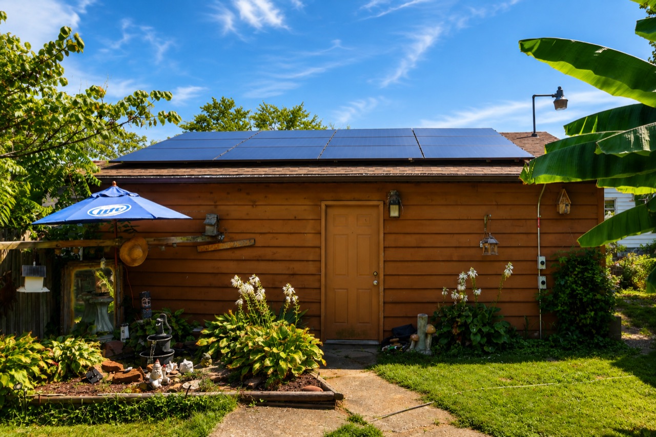 Detached garage with rooftop solar panels in an Illinois backyard